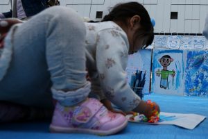 HIMEJI JAPAN-APRIL 2: A Japanese child writes art as massage for light it up blue campaign for world Autism Awareness Day on April 2, 2015 in Himeji, Japan. World Autism Awareness Campaign Day mark on April 2 every year as many cities all over the world participate in this Light It Up Blue Campaign by lighting about 2,000 iconic buildings and landmarks blue, to bring honor all the families that are affected by autism. (Photo by Buddhika Weerasinghe/Getty Images)