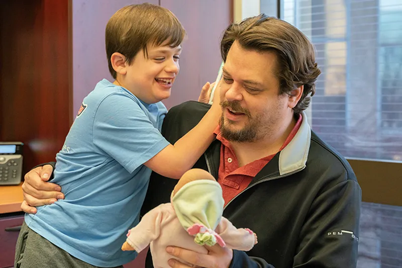 autism-fragile-x-studies-northwestern-neurodevelopmental-diversity-lab autistic youth playing laughing hug northwestern neurodevelopmental diversity lab