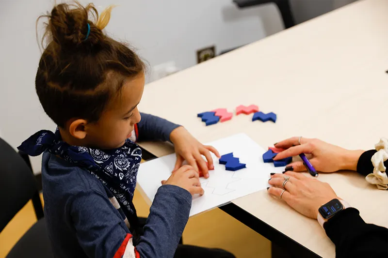 support-autism-research-at-northwestern-neurodevelopmental-disabilities-lab autistic child working on a puzzle northwestern neurodevelopmental diversity lab